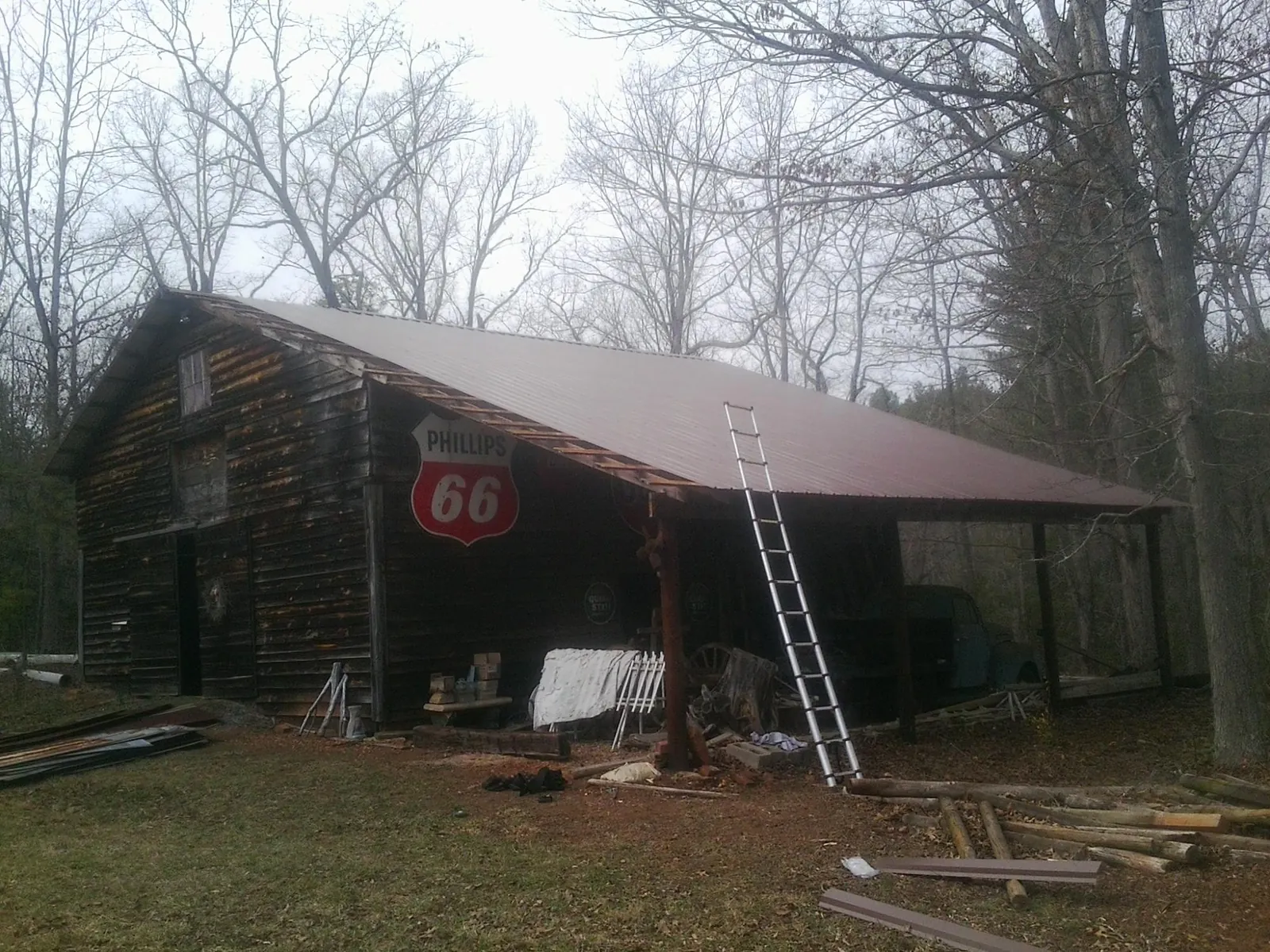 New metal roof on an open sided timber barn with a vintage sign in Bozman