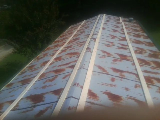 Rusted metal roof panels with new wood purlins before replacement — Storm Damage Roof Repair in Bozman by Roofing Brothers
